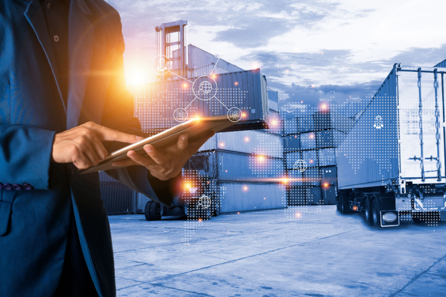 A man in a suit holds a tablet and stylus, while around him are transportation solutions, including trucks on a highway