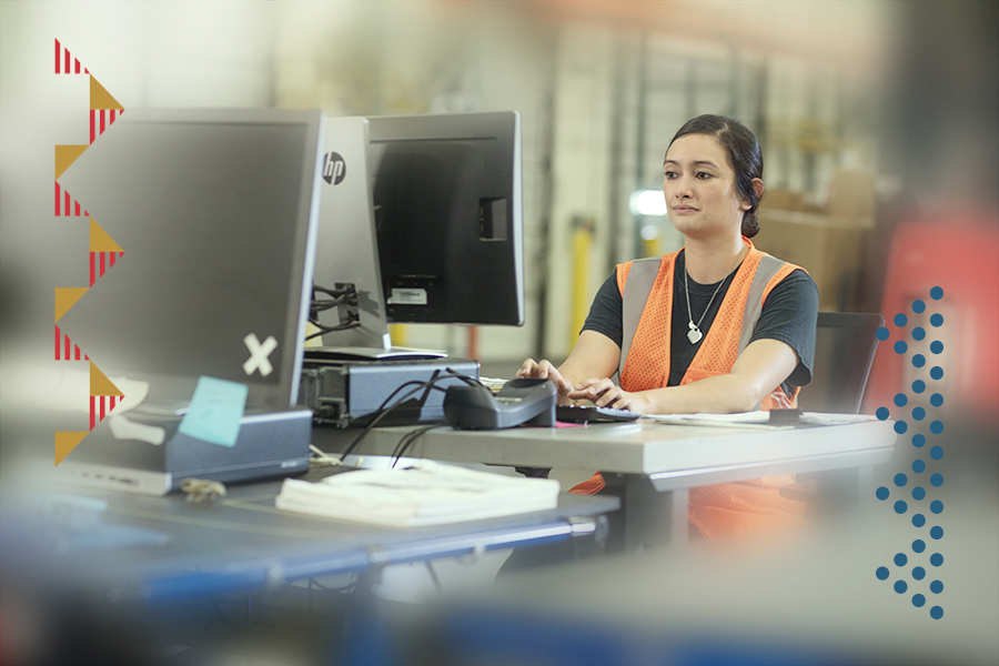 A fulfillment center employee working on a computer