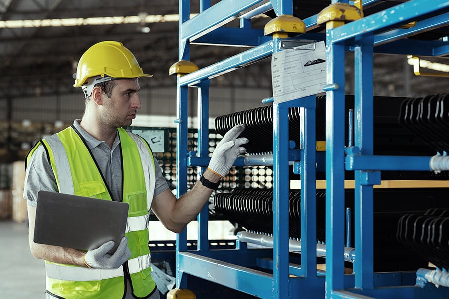 Warehouse employee checking car part inventory