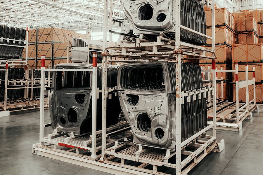 Rows of car doors being stored in a warehsouse