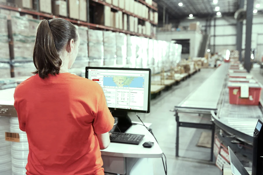 employee at a distribution center facility with a desktop computer