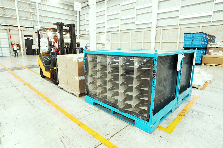 warehouse worker moving pallets on forklift